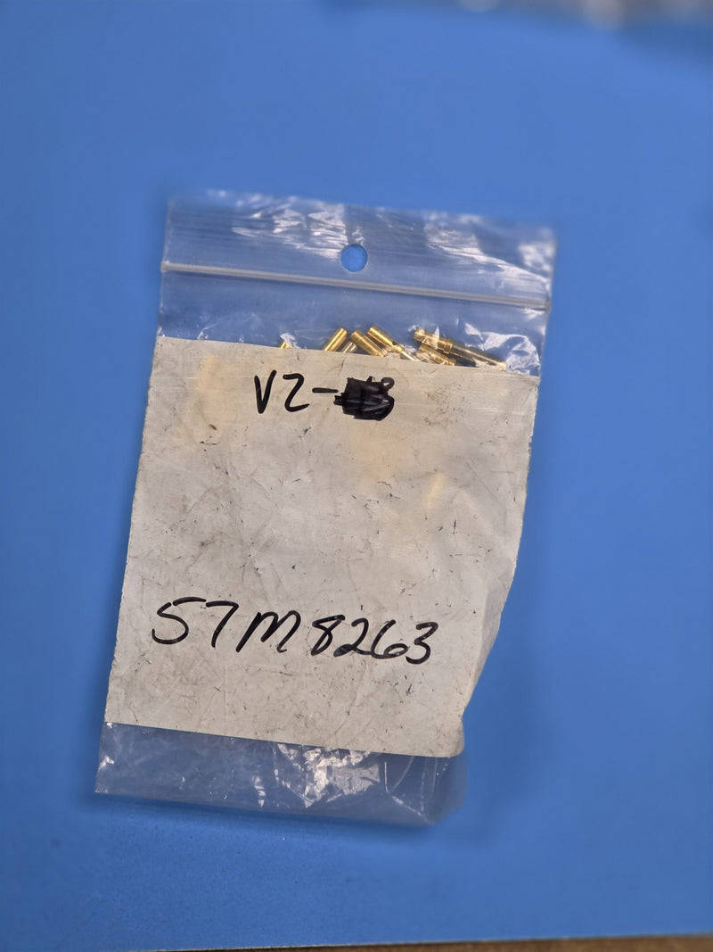 Bag marked 57M8263 holding small brass hardware, on the shelf at AIM Rentals Prince George