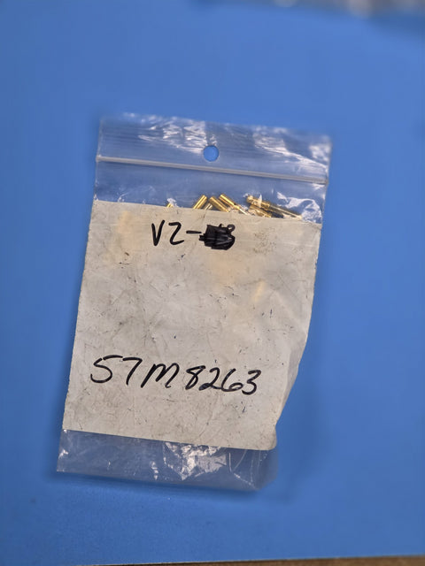 Bag marked 57M8263 holding small brass hardware, on the shelf at AIM Rentals Prince George