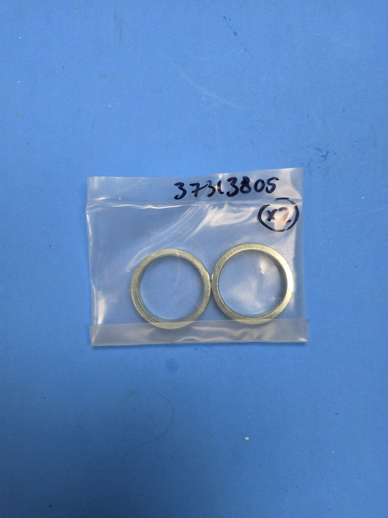 Hand written 37313805 bag holding two brass ring spacers on the Prince George BC shelf