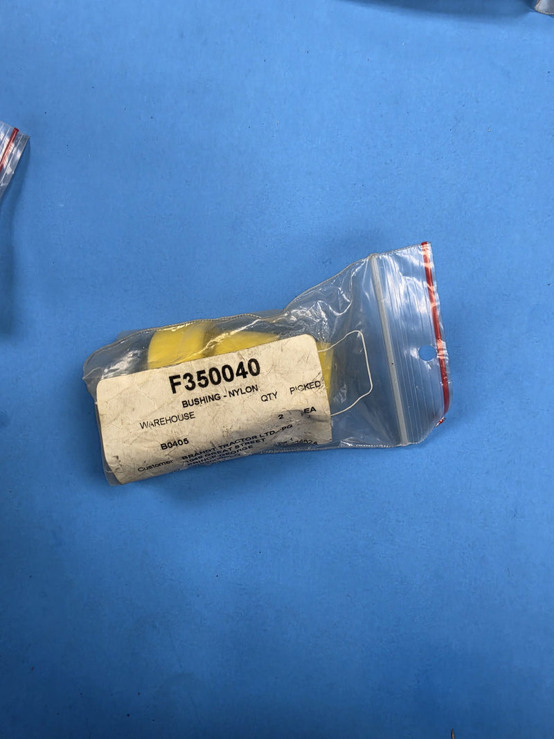 Yellow nylon bushings in a bag labelled F350040 BUSHING NYLON at AIM Rentals Prince George