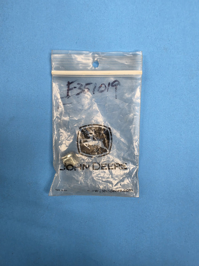 Genuine John Deere bag hand marked F351019 holding a small brass fitting at AIM Rentals Prince George