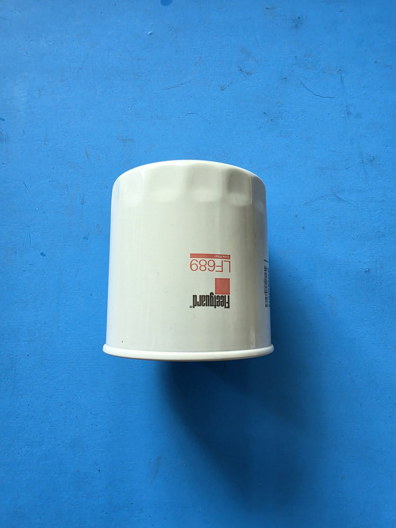 Genuine Fleetguard LF689 lube filter, small unwrapped spin on can with barcode label, on the bench in Prince George BC