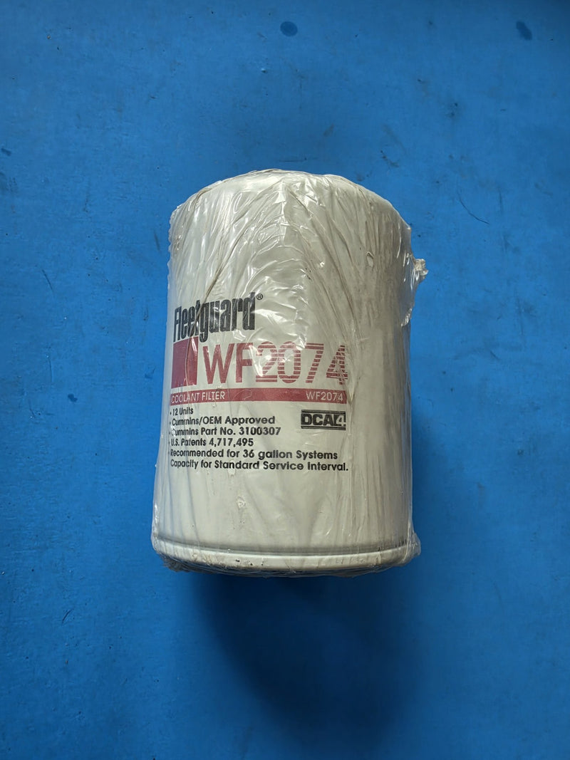 Genuine Fleetguard WF2074 spin on coolant water filter, still shrink wrapped, Cummins part number 3100307 and DCA4 printed on the can, photographed on the shelf in Prince George BC