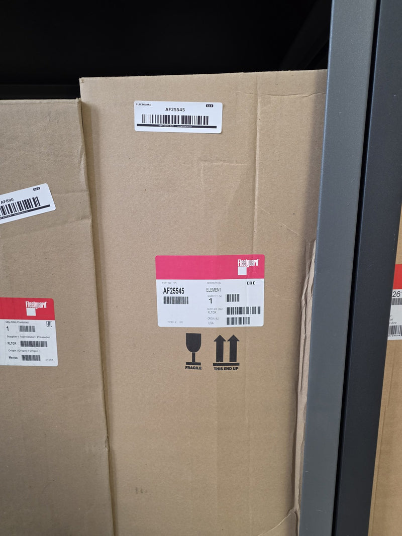 Genuine Fleetguard AF25545 air filter element in a tall sealed carton marked fragile and this end up, origin USA, photographed on the rack in Prince George BC