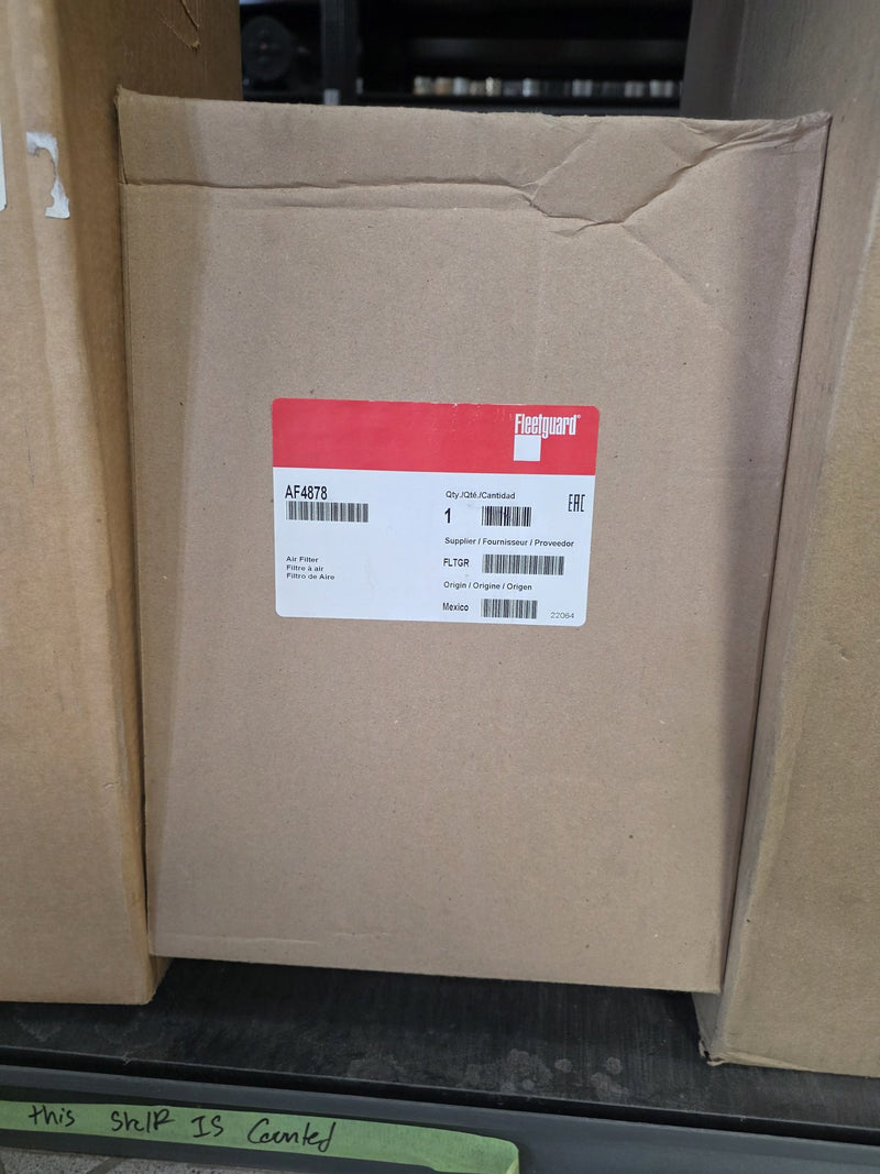 Genuine Fleetguard AF4878 air filter in a sealed carton, origin Mexico with date code 22064, sitting on a counted shelf in Prince George BC