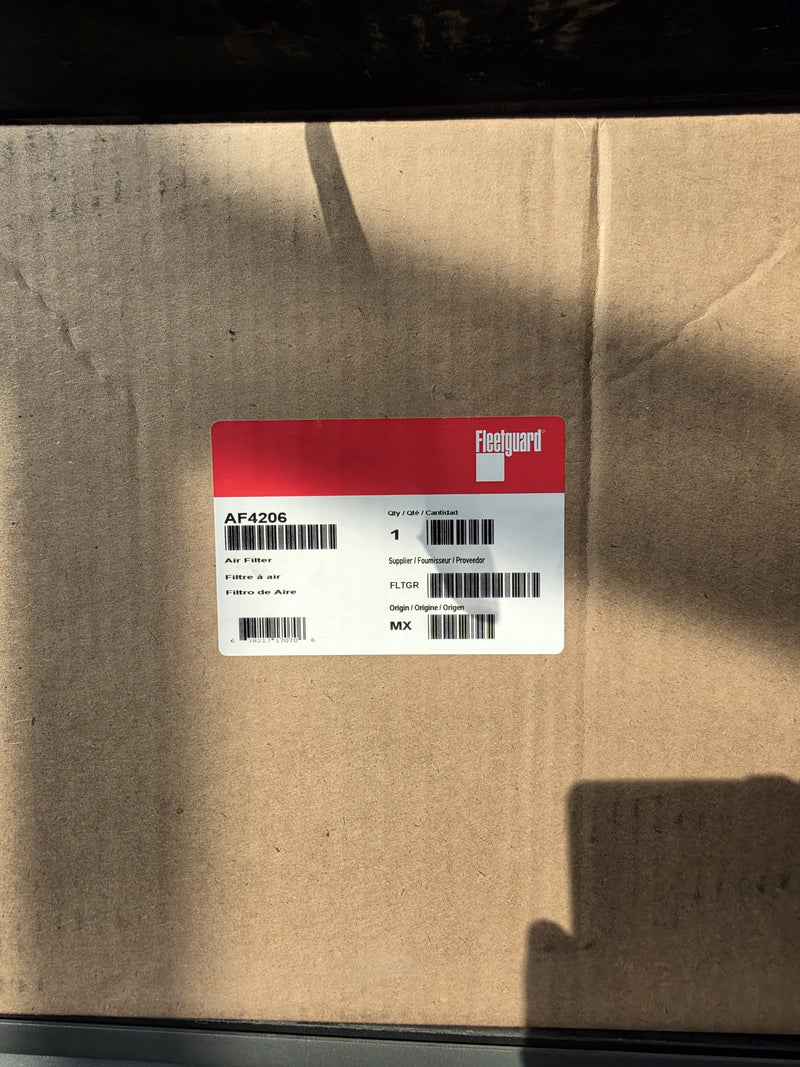 Genuine Fleetguard AF4206 primary air filter in a large sealed carton, origin MX label, photographed in daylight on the rack in Prince George BC