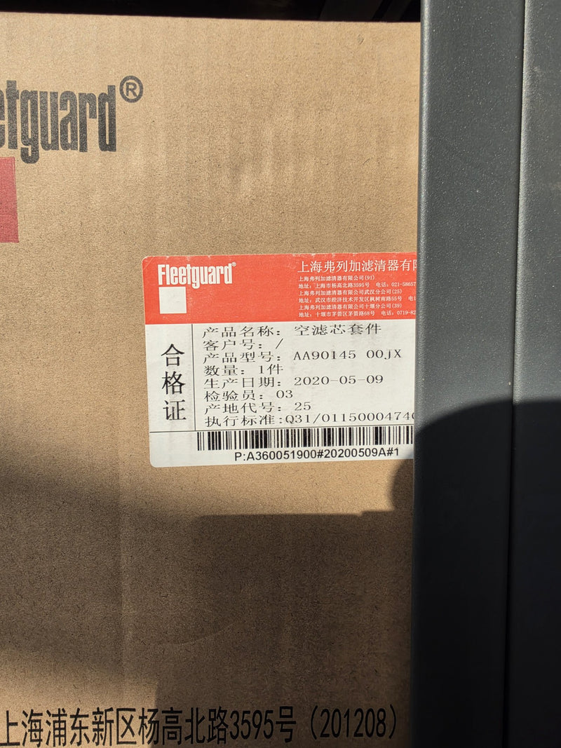 Genuine Fleetguard AA90145 air filter kit in a large Fleetguard carton with a Shanghai Fleetguard certificate label reading air filter element kit, photographed in Prince George BC